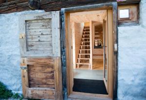 an open door to a house with a ladder at Mountain Cabin Got Spess Lenzerheide in Obervaz