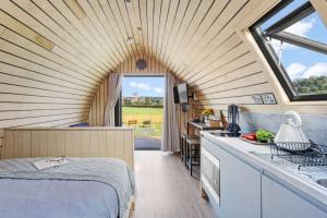 a room with a bed and a kitchen with a window at The West Front, Cathedral View in Wells