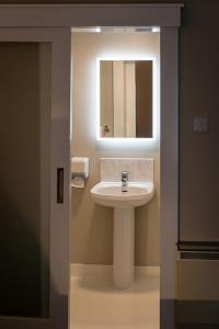 a bathroom with a sink and a mirror at Tralee Townhouse in Tralee