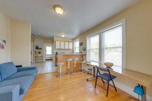 a living room with a blue couch and a table at Bright St Louis Abode 5 Mi to Forest Park! in Southhampton