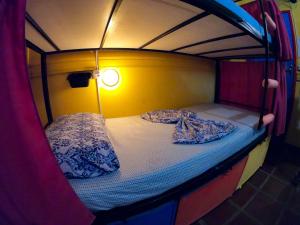 a bunk bed with two pillows on top of it at Solar Hostel Búzios in Búzios