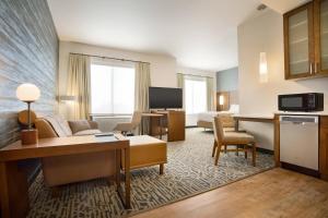 a hotel suite with a living room and a kitchen at Residence Inn by Marriott Phoenix Chandler/South in Chandler