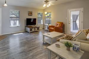 a living room with a couch and a table at Ideally Located Austin Home with Fenced-In Yard! in Austin