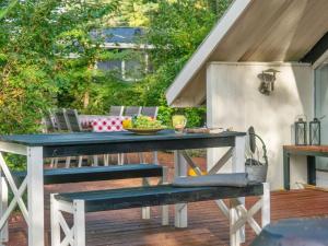 a picnic table with a bowl of fruit on a patio at Holiday Home Ninni - 3-2km from the sea in Sealand by Interhome in Eskebjerg