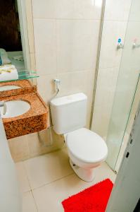 a bathroom with a toilet and a sink and a shower at Hotel Italia Beach in Natal