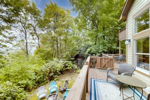 a deck with a table and chairs and a pool at Pisgash Cottage in Pisgah Forest