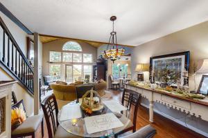 a living room with a table and a dining room at Pisgash Cottage in Pisgah Forest