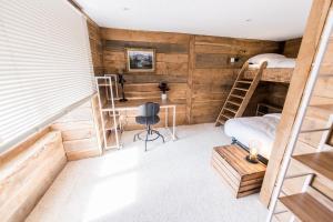 a room with two bunk beds and a desk at Le Milan Royal - Montmin in Montmin