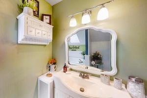 a bathroom with a white sink and a mirror at Pisgash Cottage in Pisgah Forest +21 photos