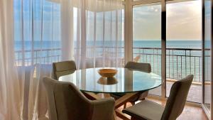 a dining room with a table and a view of the ocean at Beachfront Havana in Sveti Vlas