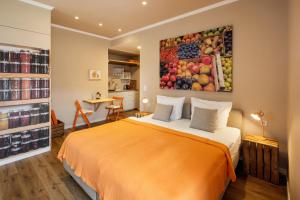 a bedroom with a bed and a painting of fruit at Schloss Hertefeld & Hertefeldhof in Weeze