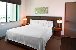 a bedroom with a large white bed and a window at Element Dallas Fort Worth Airport North in Irving