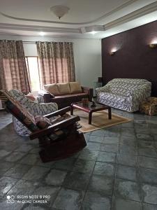 a living room with a couch and a bed at Chácara ADLUC in Cascavel