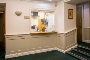 a waiting room with a counter with a mirror at Tralee Townhouse in Tralee