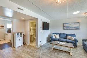 a living room with a blue couch and a table at Wildwood Crest Condo Rental Walk to Beach! in Wildwood Crest