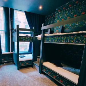 a room with three bunk beds in a room at The Queen Street Bunkhouse in Newcastle upon Tyne