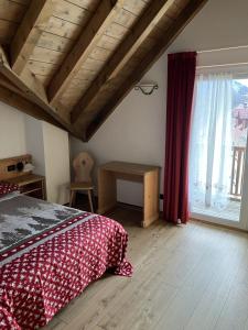 a bedroom with a bed and a large window at Giongo Residence Aparthotel 103 in Lavarone