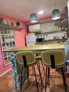 a kitchen with a table and two chairs at Cueva Colorin Alloza. in Alloza