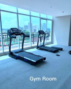two tread machines in a room with a large window at Wiwi Formosa Residence Nagoya with Balcony-Spacious-Netflix in Nagoya