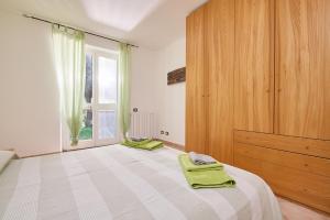 a bedroom with a bed with green towels on it at Verde - Euroappartamenti in San Vincenzo +14 photos