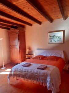 a bedroom with a bed and a wooden ceiling at La maison du haut in Ponet-et-Saint-Auban