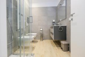 a bathroom with a shower and a toilet and a sink at BergamoCityCenter 02 in Bergamo