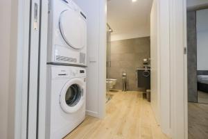 a laundry room with a washer and dryer in it at BergamoCityCenter 02 in Bergamo +3 photos