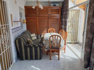a room with a table and chairs on a balcony at Coqueto alojamiento en Los Alcázares in Los Alcázares