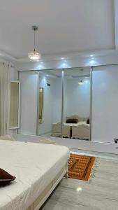 a bedroom with a large mirror and a bed at Dar Al Yaqout in Al Karm