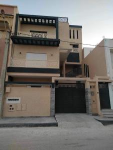 a large house with a garage door in front of it at Dar Al Yaqout in Al Karm