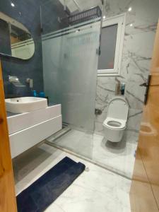 a bathroom with a toilet and a sink at Dar Al Yaqout in Al Karm