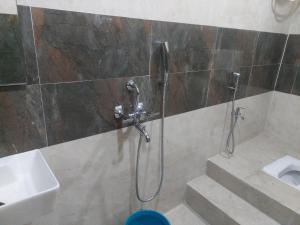 a shower in a bathroom with a sink and a toilet at DREAM HOTEL in Purulia +28 photos
