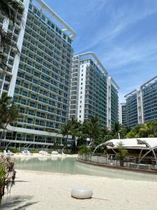 a white frisbee on the beach in front of buildings at Condo in Azure Urban Resort Residences-Paranaque City in Manila