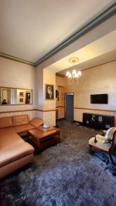 a living room with a couch and a fireplace at NF Palace Old City Bucharest in Bucharest