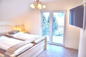 1 dormitorio con 1 cama y puerta corredera de cristal en Luxury villa 2-10 people with Sauna close to Lift / FIS Ski slope en Sankt Michael im Lungau