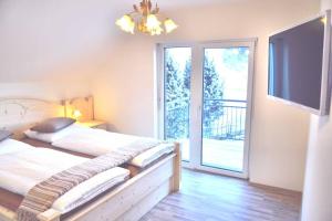 a bedroom with a bed and a sliding glass door at quiet and central Luxury Villa "JUWEL" with Sauna, at Ski slope! in Sankt Michael im Lungau