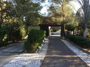 a walkway with a bridge in a park at San Isidro Suite in Las Heras