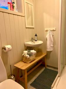 a small bathroom with a sink and a table with a sink at Skjerping gårdshus, in Lonevåg