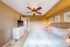 a bedroom with a bed and a ceiling fan at Jamaica IV 209 in Ocean City