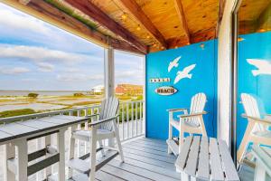 a porch with a table and chairs and a view of the ocean at Jamaica IV 209 in Ocean City