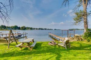 a picnic table and benches next to a lake at WolcottandPort Bay Lakehouse Your Haven on the Bay! in Wolcott