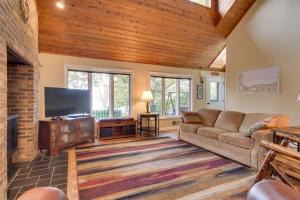 a living room with a couch and a flat screen tv at WolcottandPort Bay Lakehouse Your Haven on the Bay! in Wolcott