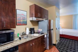a kitchen with a sink and a refrigerator in a room at TownePlace Suites by Marriott Atlanta Kennesaw in Kennesaw