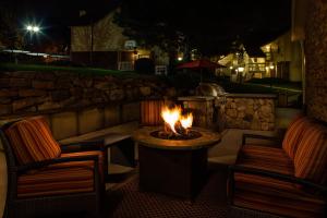 a fire pit in a patio at night with two chairs at Residence Inn Shelton Fairfield County in Shelton