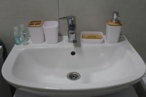 a white sink with toiletries on top of it at ЖК Терра in Almaty