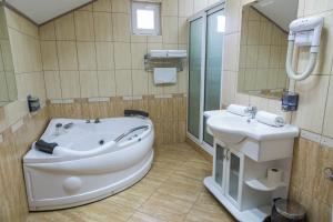 a bathroom with a tub and a sink at VILA STASEA in Smederevo