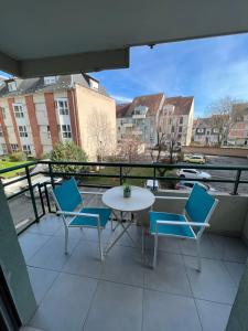 a balcony with a table and chairs and a view at STUDIO COSY STRASBOURG CENTRE TRAM in Strasbourg