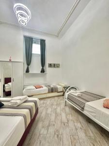 a room with three beds in it with at Appartamento Il Tempio Della Capitale in Rome