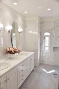 a white bathroom with two sinks and a mirror at Beautiful, Private Villa by the Sea in Aghia Marina