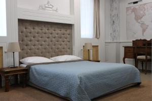 a bedroom with a large bed with a large headboard at VILA STASEA in Smederevo